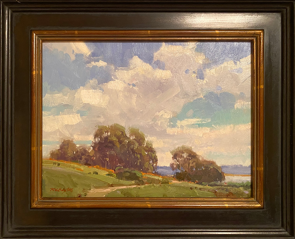 An example of an idyllic plein air painting, featuring a rolling hill and white, puffy clouds.