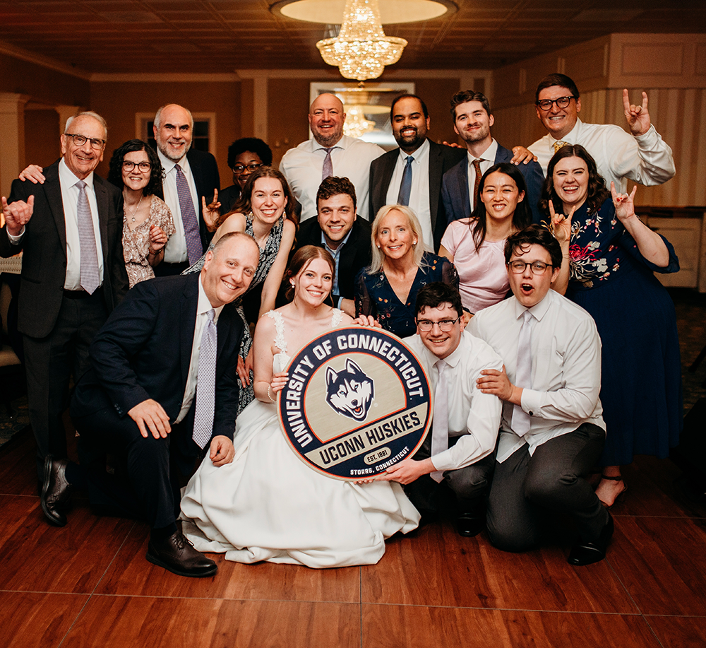 UConn admissions officer Kathleen Stango and husband Samuel Shapiro  in a group shot from their wedding.