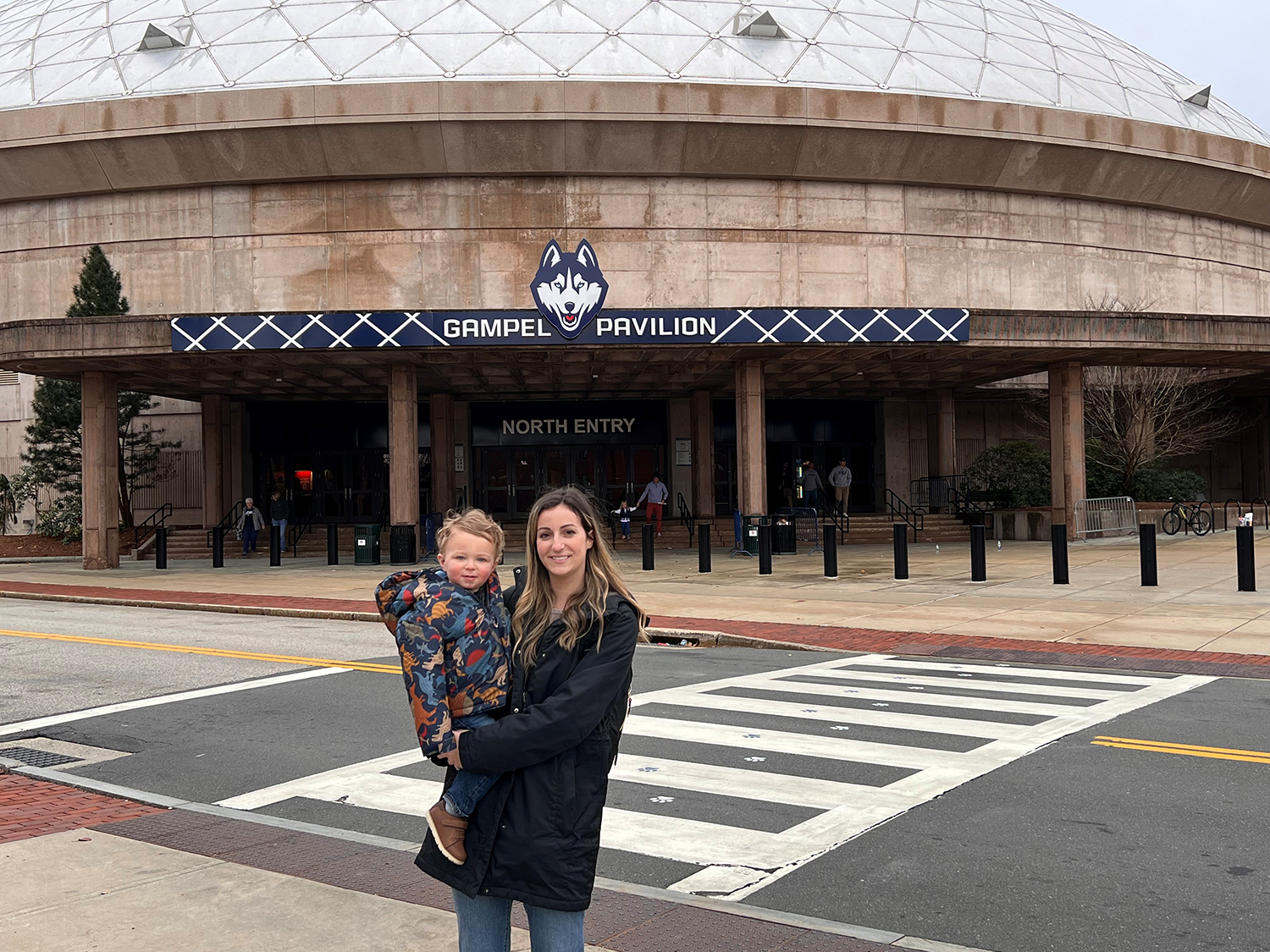 Kristy Murphy and her son pose in front of Gampel Pavilion