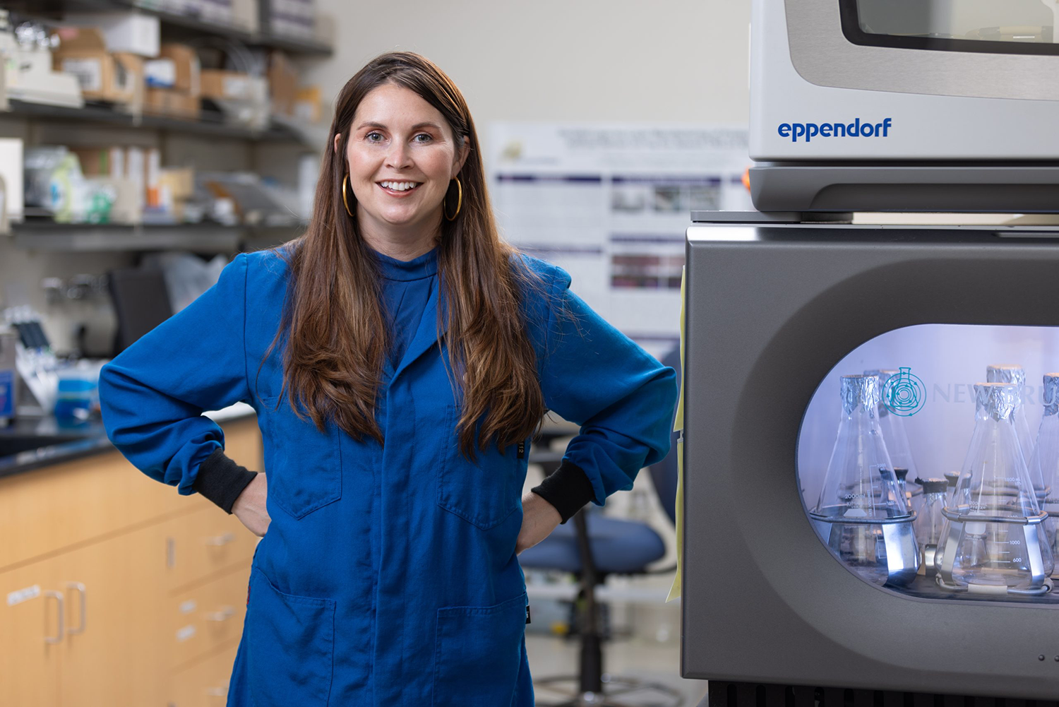 Nicole Wagner poses next to beakers and scientific equipment inside her Woodbridge-based biotechnology company Lambda- Vision.