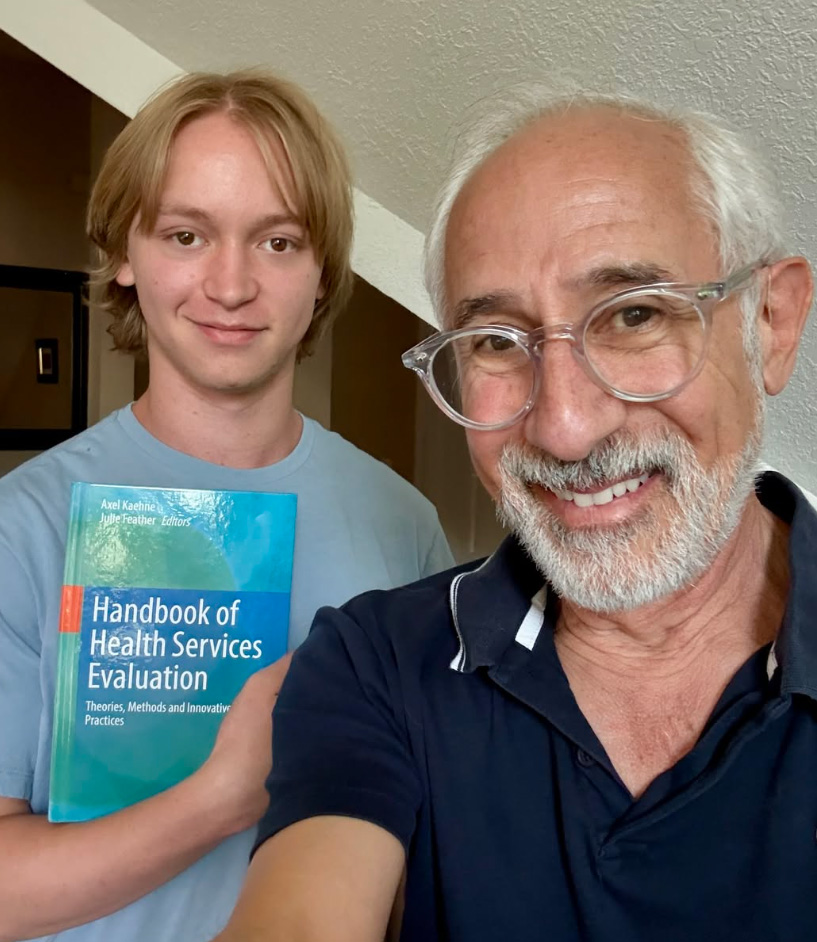 A white-haired gentleman, David Fetterman, and another person smile for the camera.
