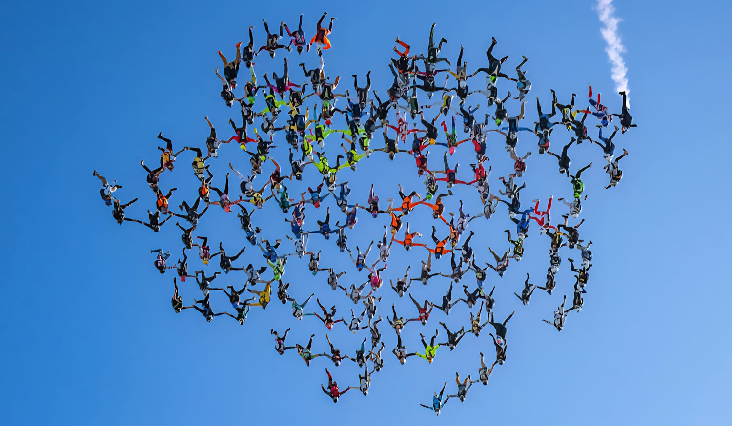 many skydivers decend during their fall in a floral like pattern