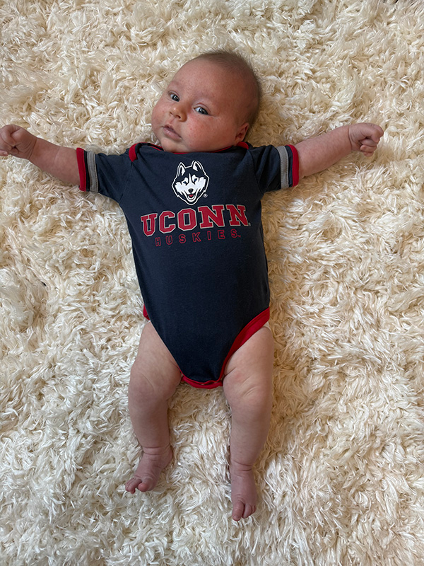 A baby in UConn onesie