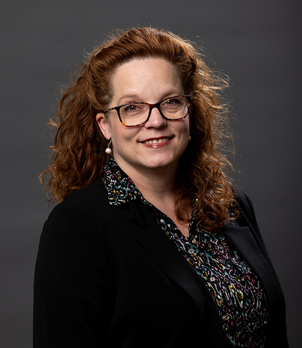 A professional portrait photo of Tara Mead