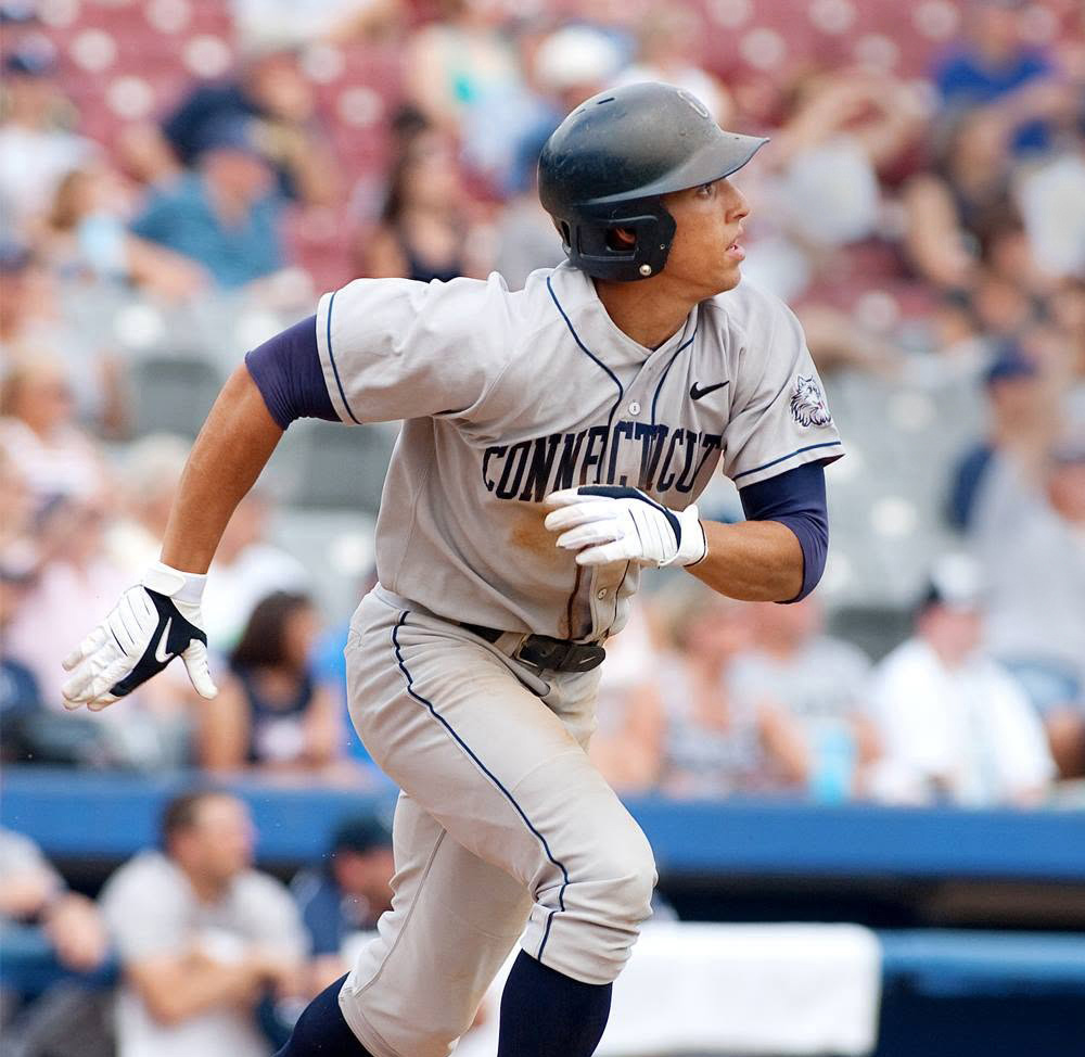 Springer in blue cap and white baseball uniform