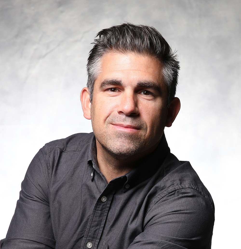 A photo portrait of Eric Panke, in gray button-up shirt.