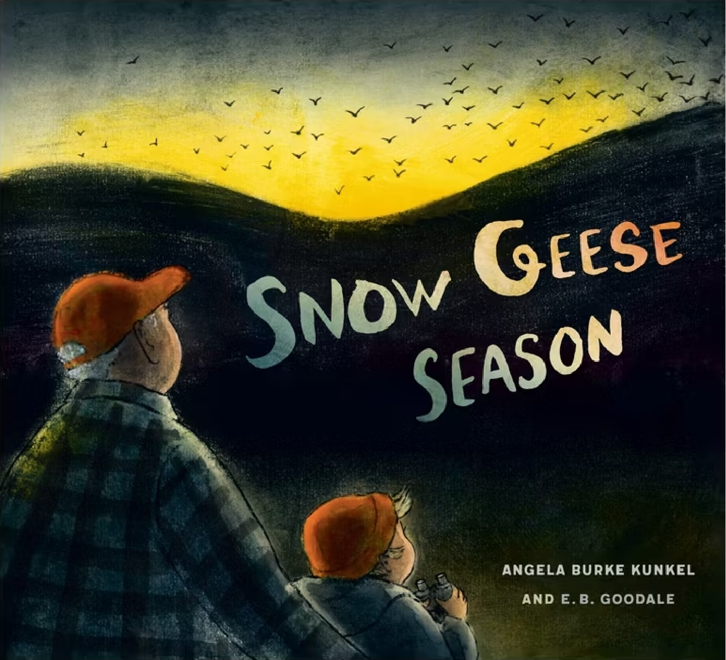 An illustrated cover for the picture book, "Snow Geese Season". A grandfather has his hand on his grandon's back as they look over a mountain range to geese flying over the yellow sunset.
