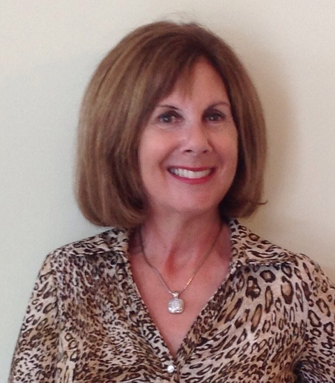 Marcie Gordon smiling for the photo in a smart blouse.