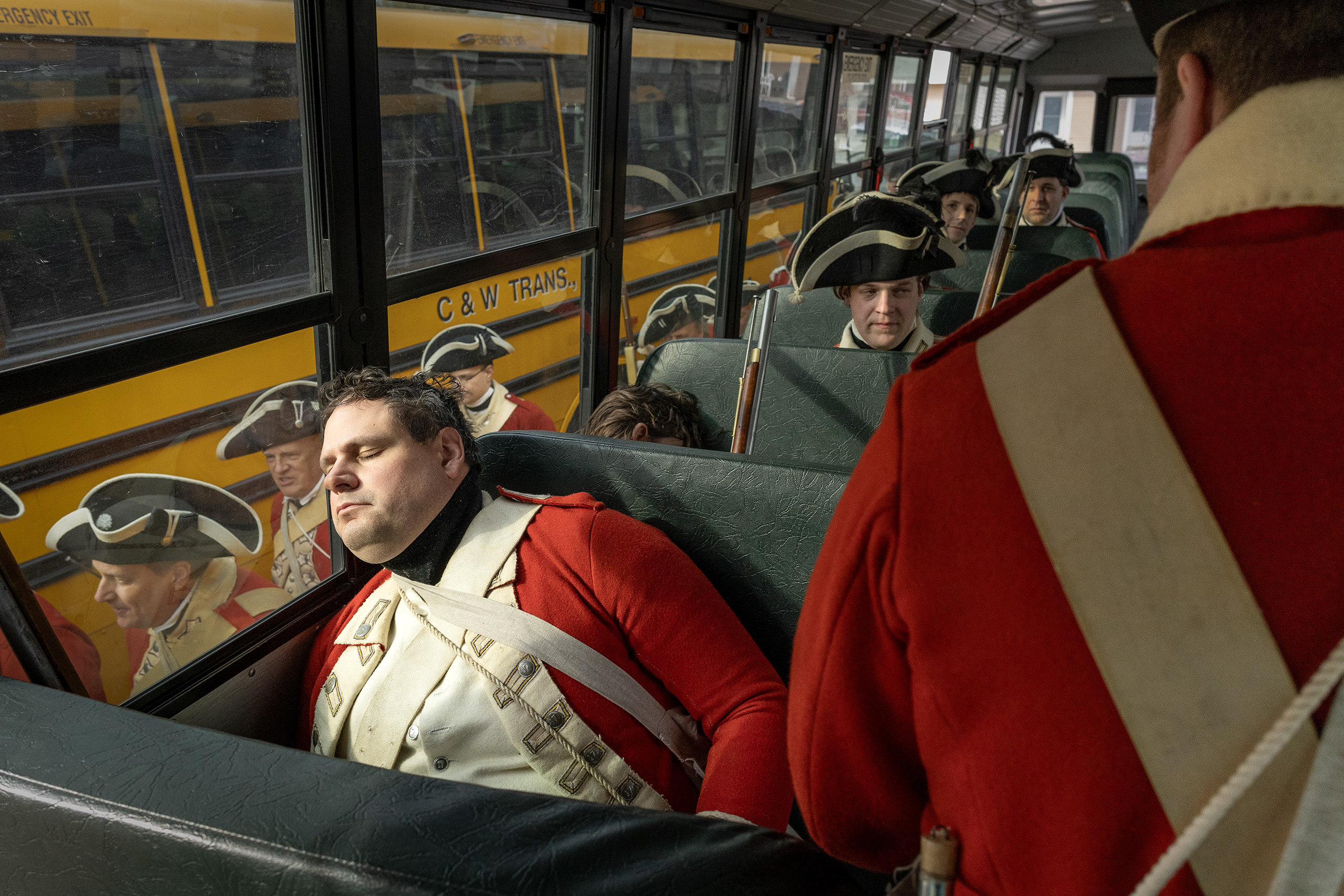 British reenactors are resting on a school bus in Lexington, Massachusetts