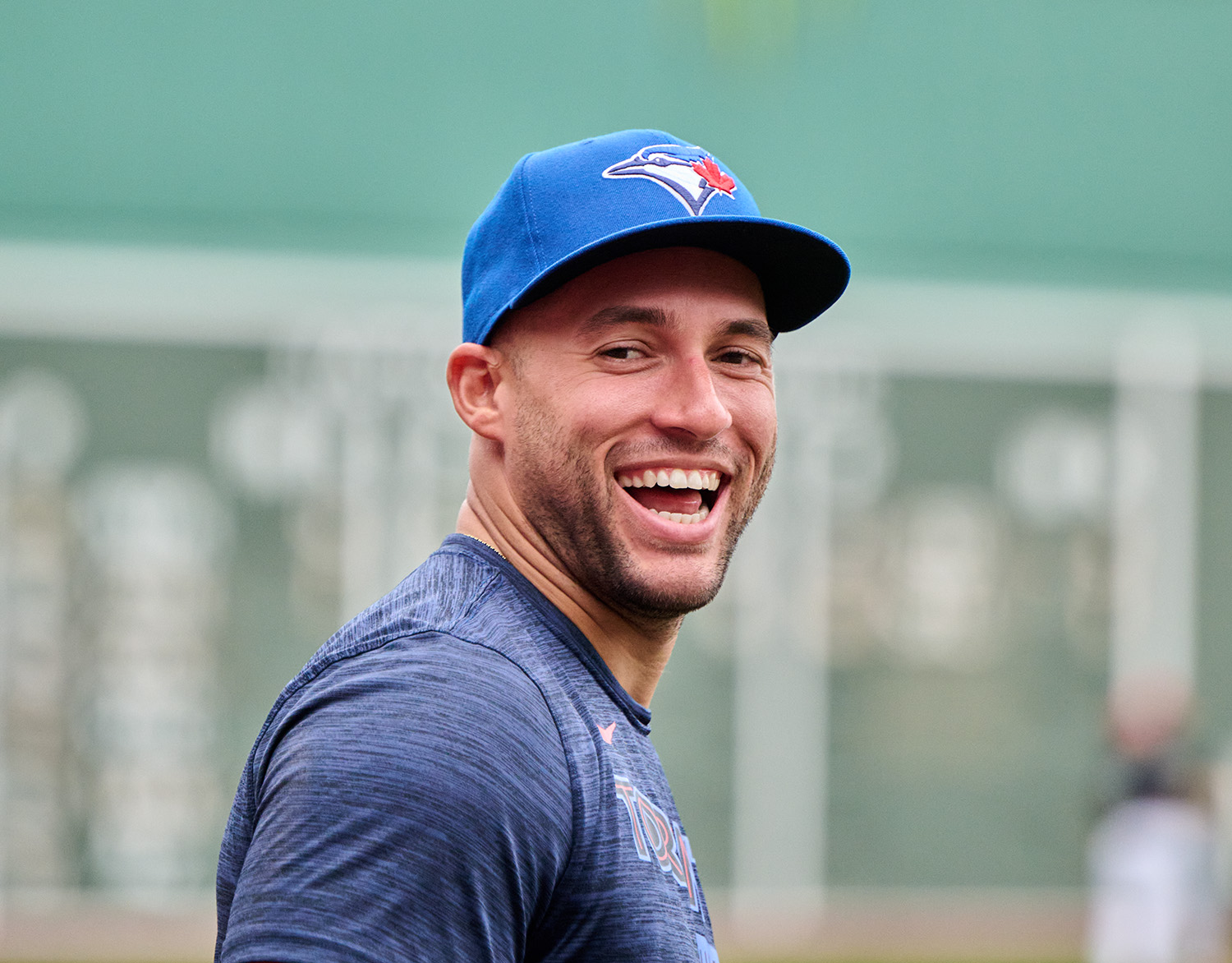 Springer in blue cap and shirt smiles gleefully at the camera.