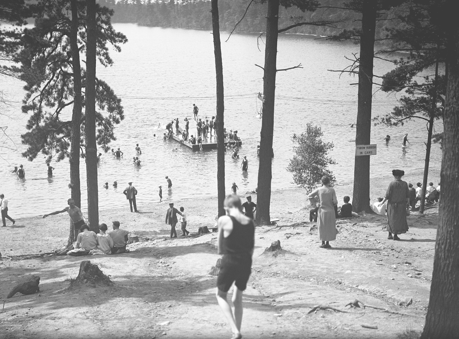 A vintage black-and-white photo of Walden Pond's swimming beach.