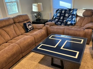 Uconn gear on a living room sofa set