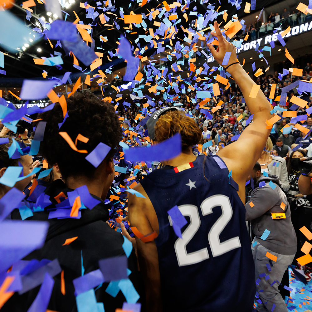 players celebrate in a rain of confetti during UConn women's basketball win against NC state in NCAA tournament
