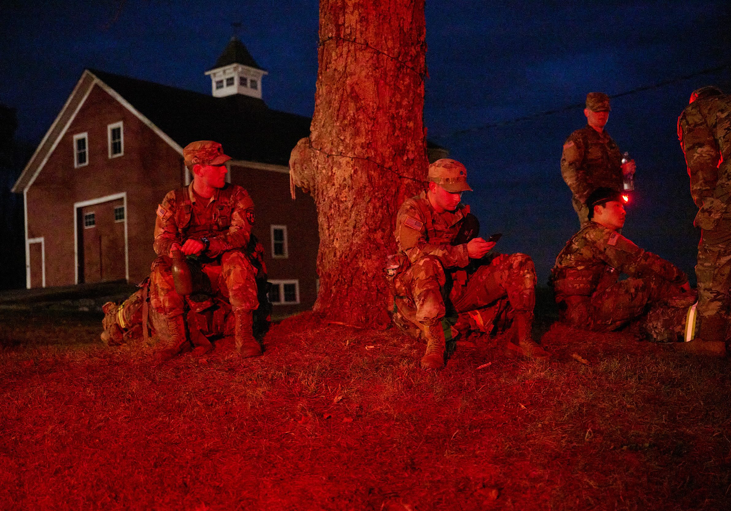 A group of uniformed ROTC students, two standing and three sitting, by a tree at Horsebarn Hill.